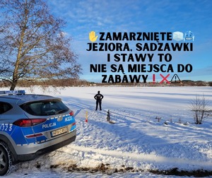 Zdjęcie stojącego policjanta na pomoście na zamarzniętym jeziorze i przy pomoście stoi policyjny radiowóz. Na zdjęciu dodano napis &quot;Zamarznięte jeziora, sadzawki i stawy to nie są miejsca do zabawy&quot;.