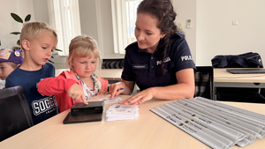 Policjantka wykonuje daktyloskopię