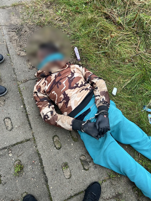 Policjanci zatrzymali mężczyznę, leży w kajdankach na ziemi