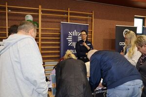 Policjanci na targach pracy rozmawiają z osobami zainteresowanymi służbą w Policji.